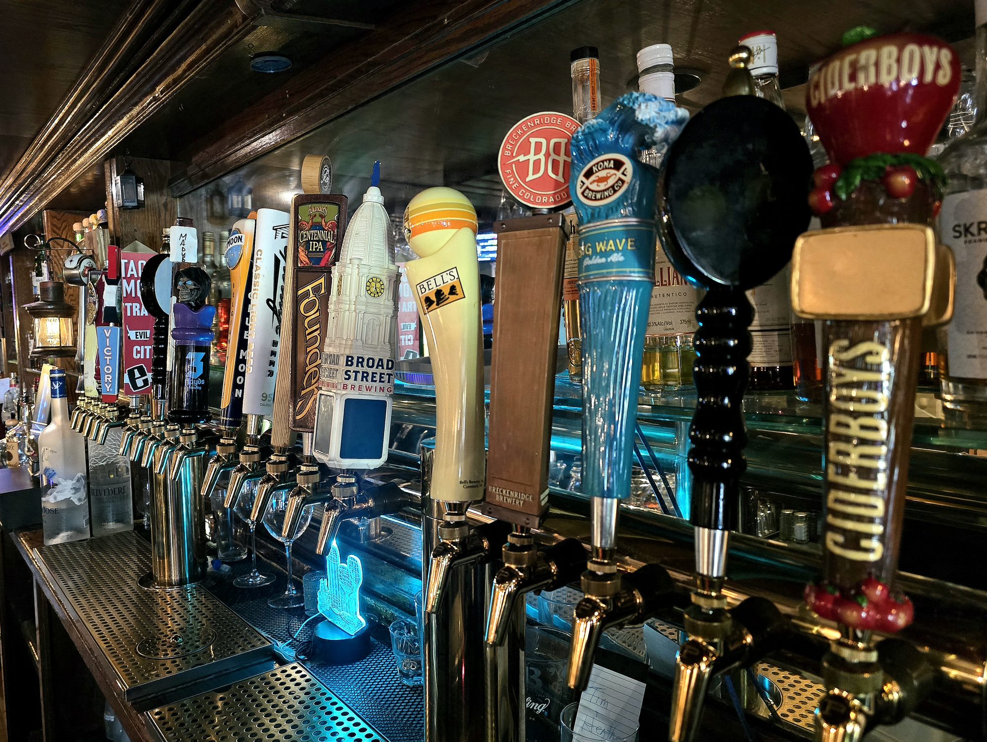 Tap handles lining the bar at the Tap & Barrel Tavern